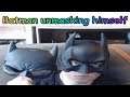 Batman reviews his masks and reveals his face